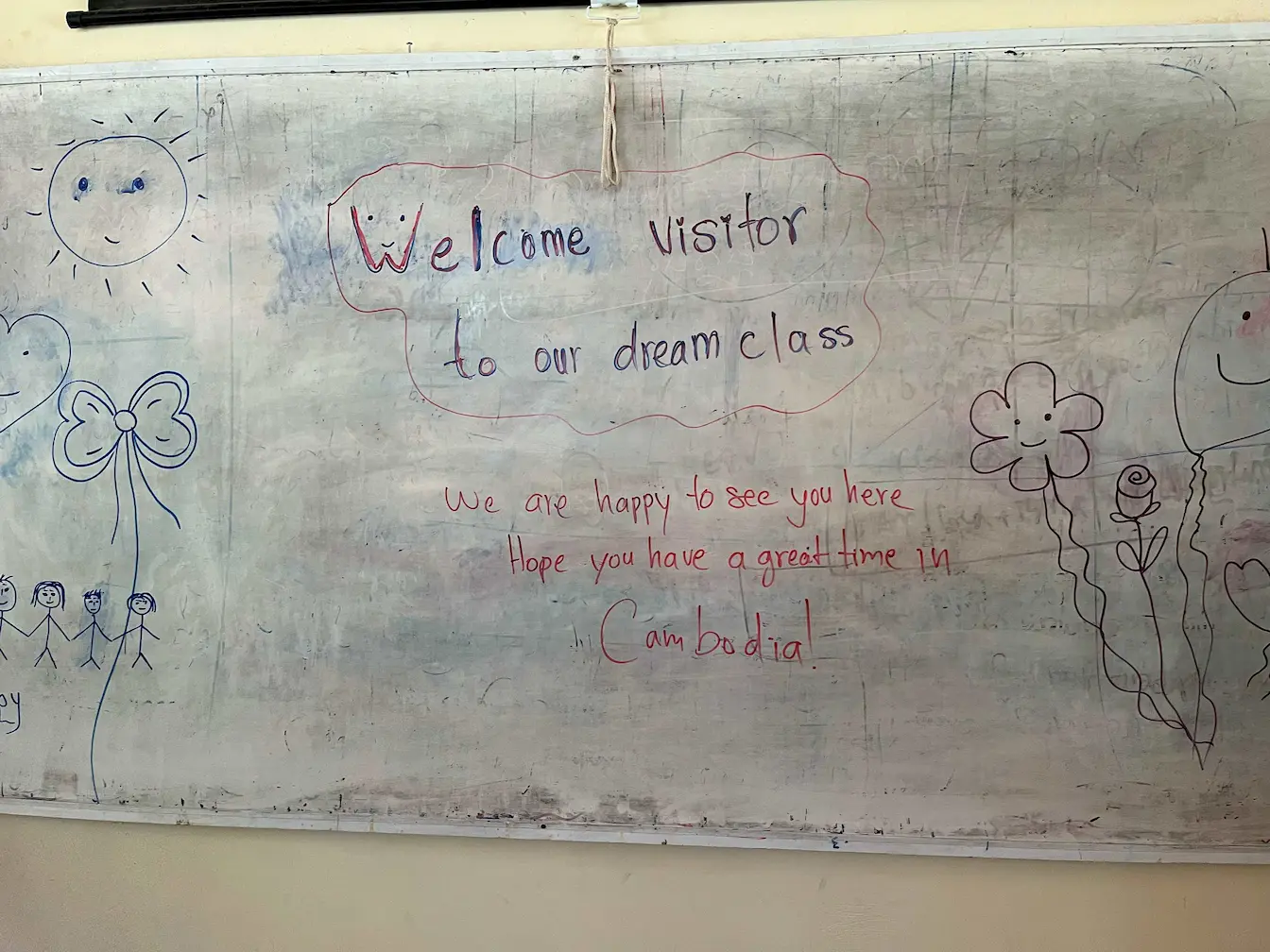 Welcom message written on a school bord for visitors supporting youth education in Southeast Asia.