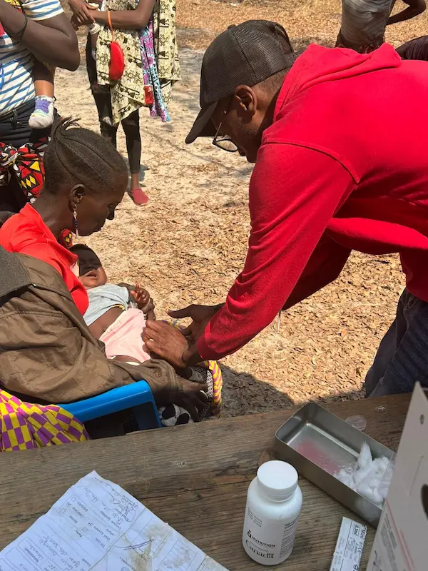 Community members gathered during the monthly vaccine day health initiative at the cattle ranch in Angola.