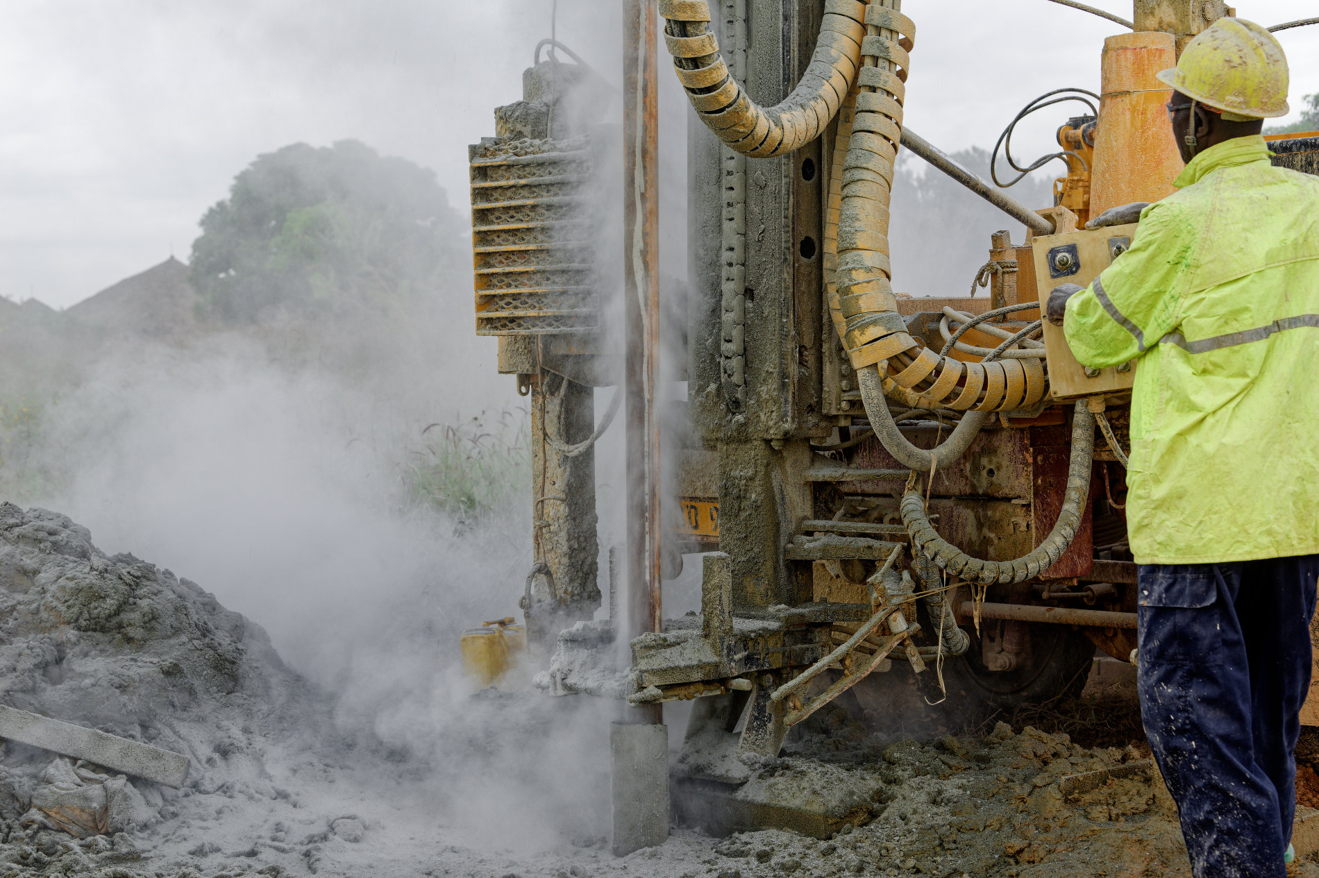 Missionaries drilling for clean water in DRC. Close-up of water and dust rising from the new well.