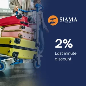 Stack of colorful suitcases on airport trolley with SIAMA 2 percent last minute discount for missionary travel