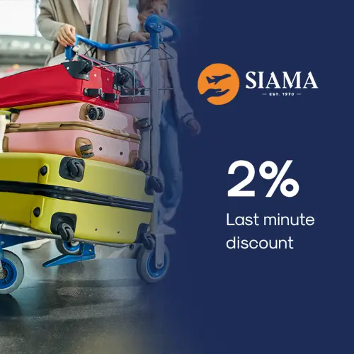 Last-Minute Missionary Travel Discount SIAMA Stack of colorful suitcases on airport trolley with SIAMA 2 percent last minute discount for missionary travel